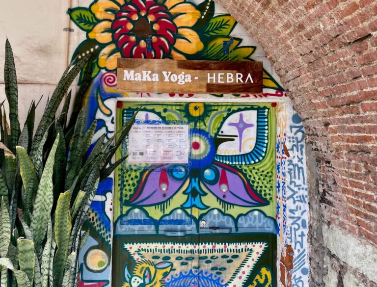 Entrance to Eva's hair salon Hebra and Maka Yoga painted with colorful artwork.