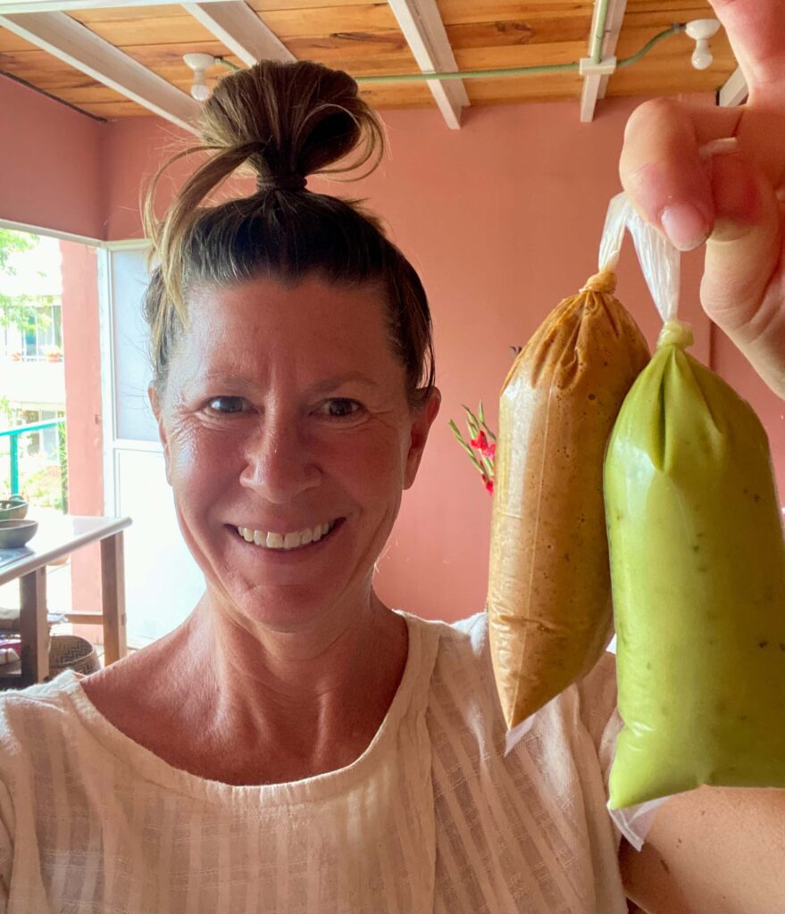 Me in my apartment in Oaxaca holding two bags of homemade salsa from Mercado Sanchez Pascuas.