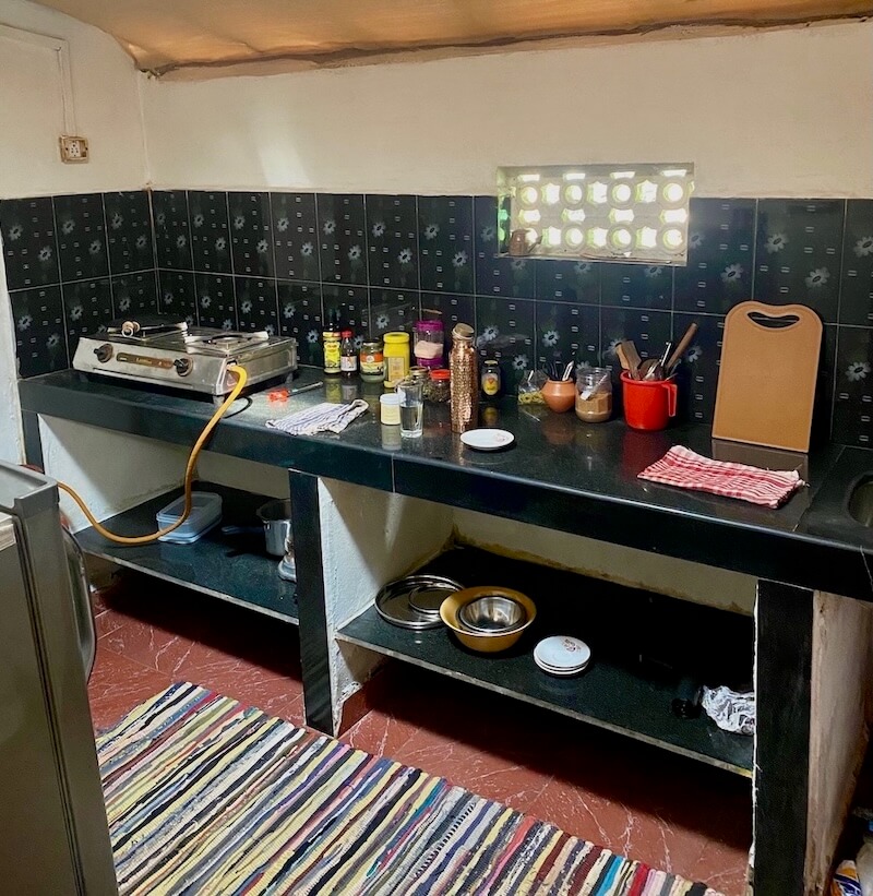 A bright kitchen with a gas cooker and many cooking utensils.