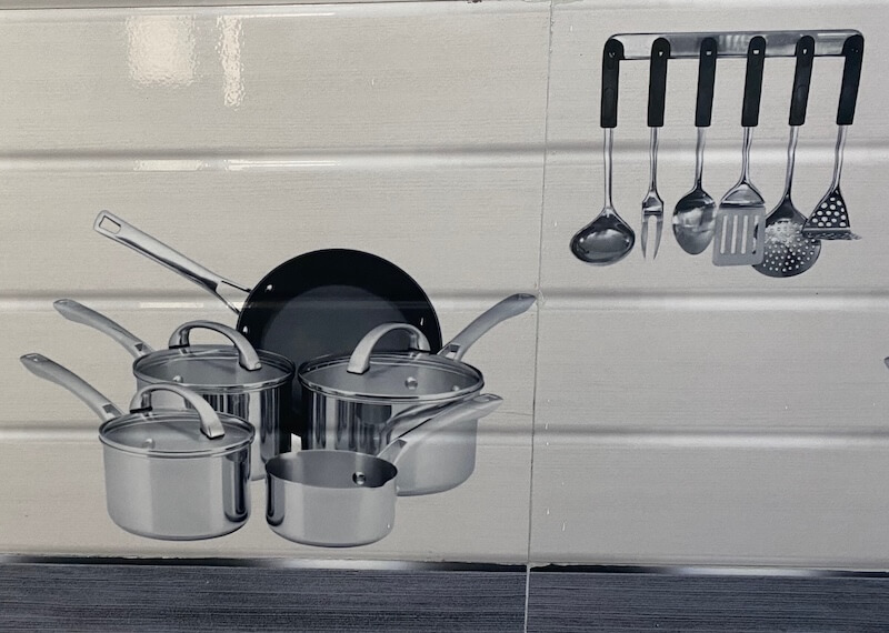 white tile painted with pictures of pots, pans and cooking utensils