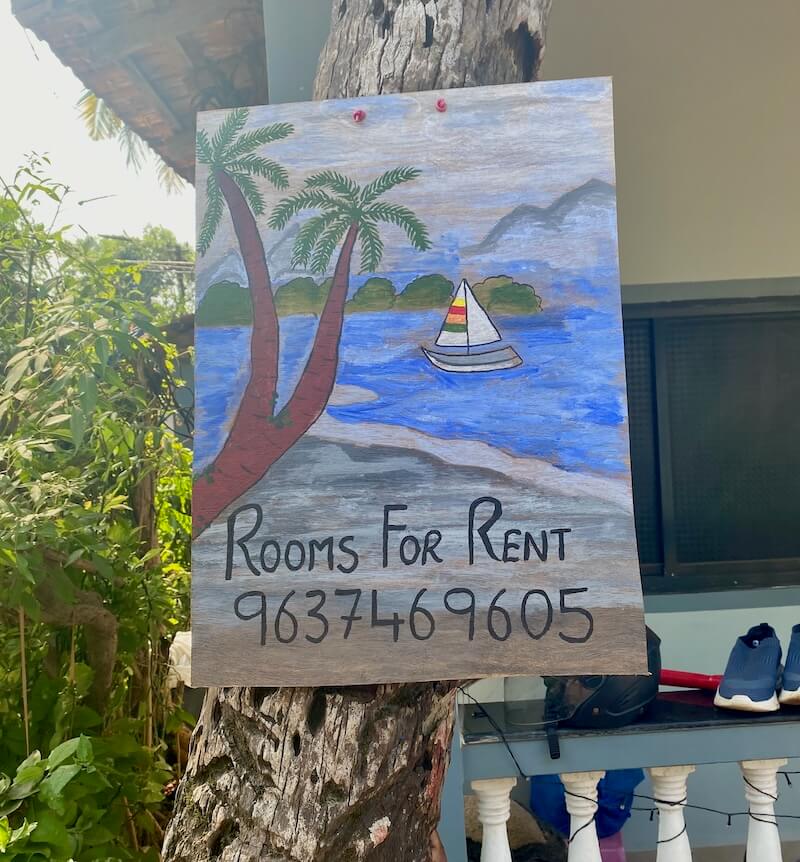 local hand-painted room for rent sign on tree